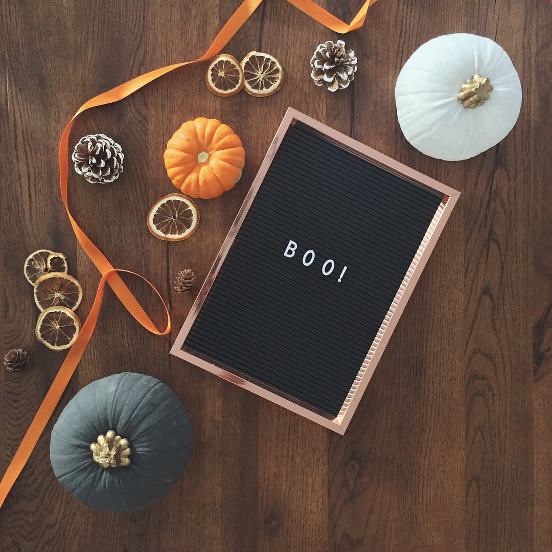 Halloween flat lay with pumpkins and Boo sign